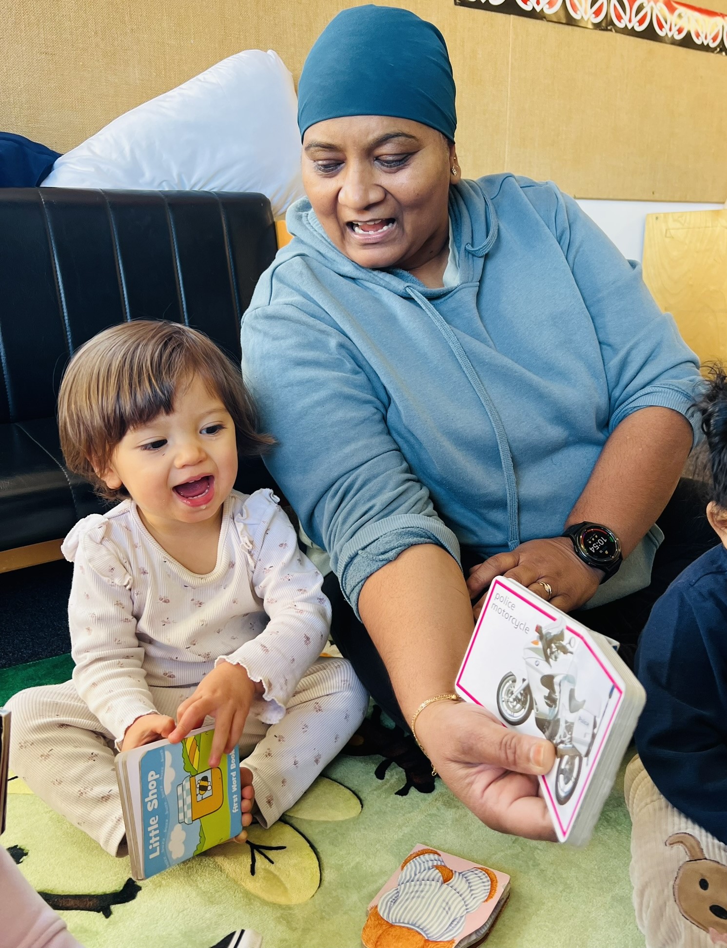 A caring teacher interacting with a happy baby